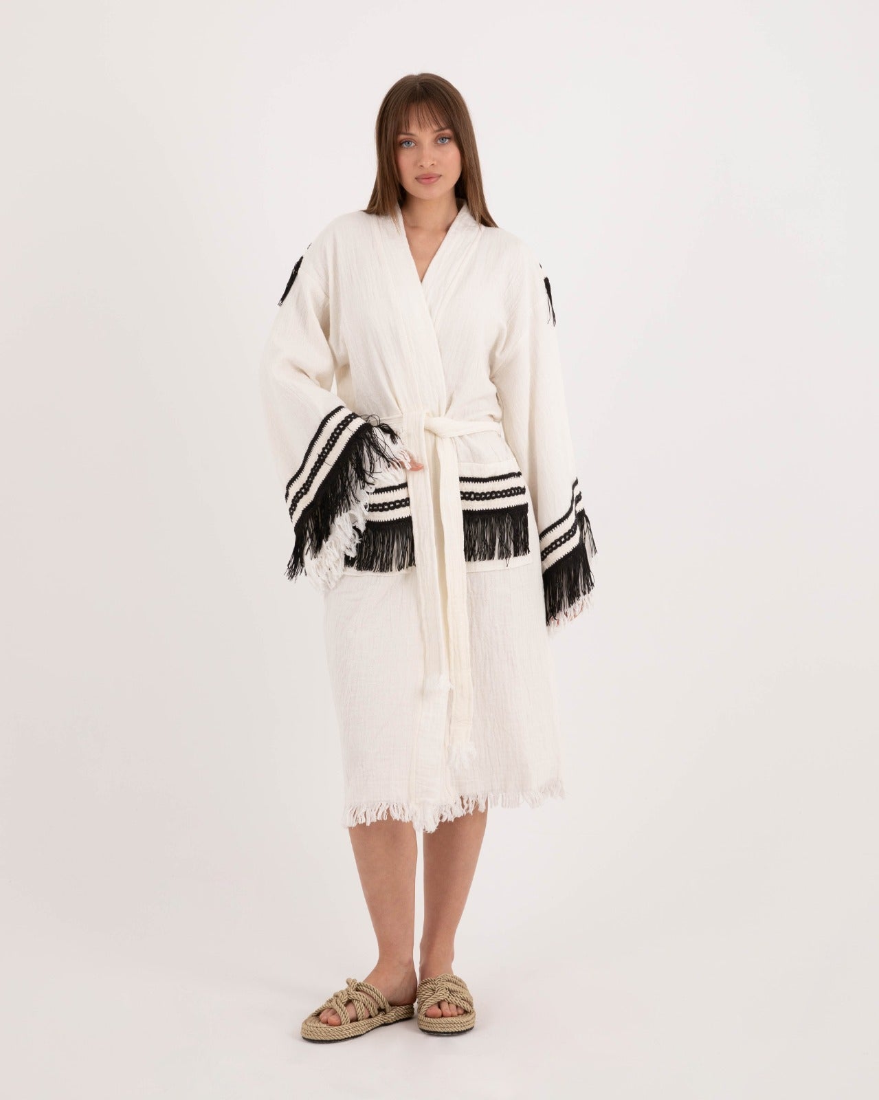 Black tassel robe by Just Jas featuring a relaxed fit, flowing fabric, and elegant tassel details on the sleeves and hem.